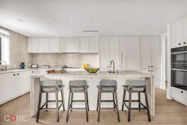 a kitchen with a table chairs stove and cabinets