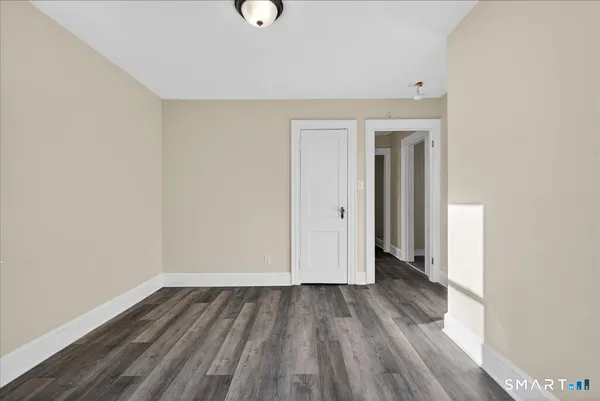 a view of a room with wooden floor