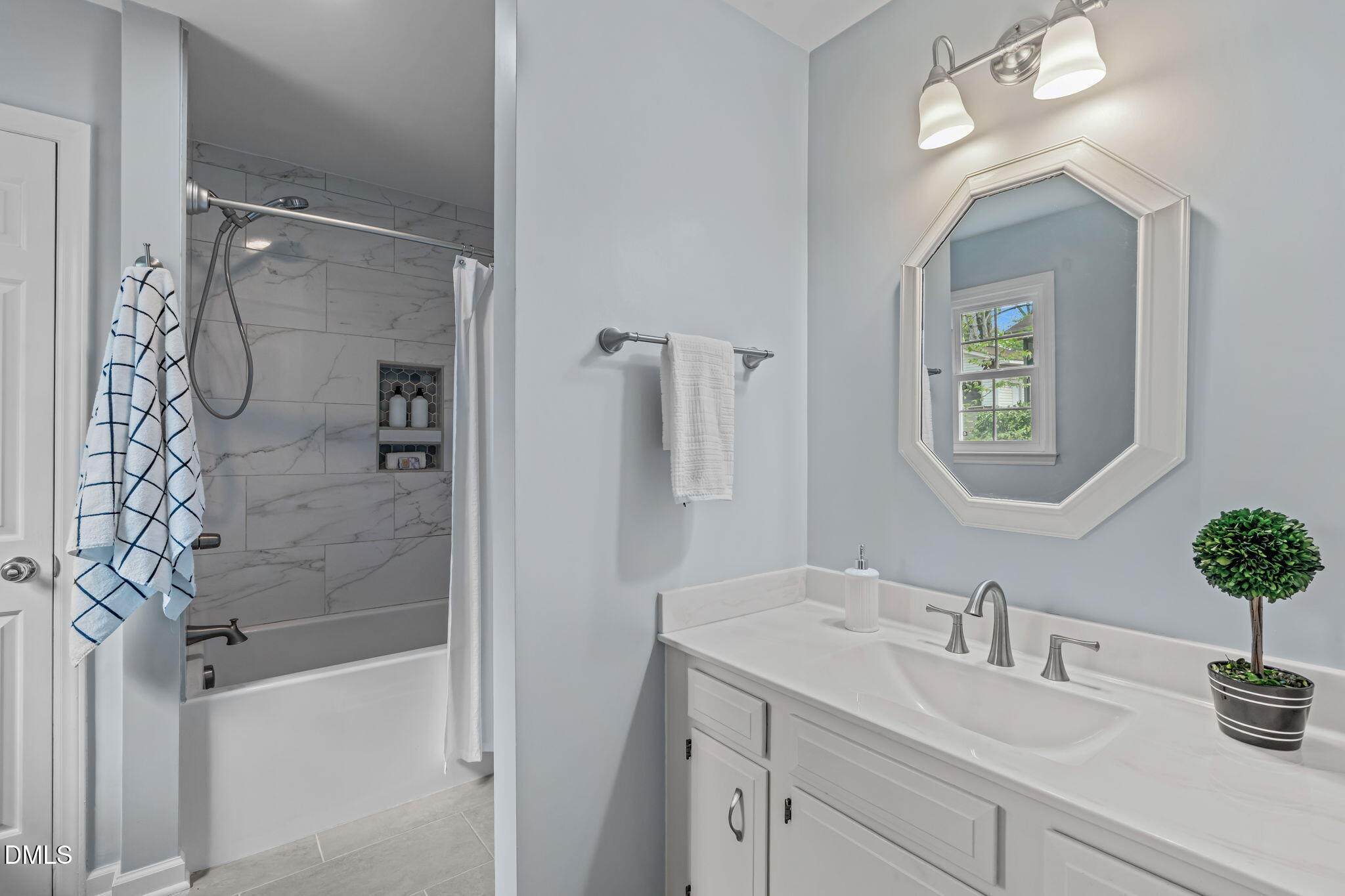 3304 Wade Avenue Raleigh, NC 27607 - Photo 21 of 38 a bathroom with a granite countertop sink a mirror a vanity and shower