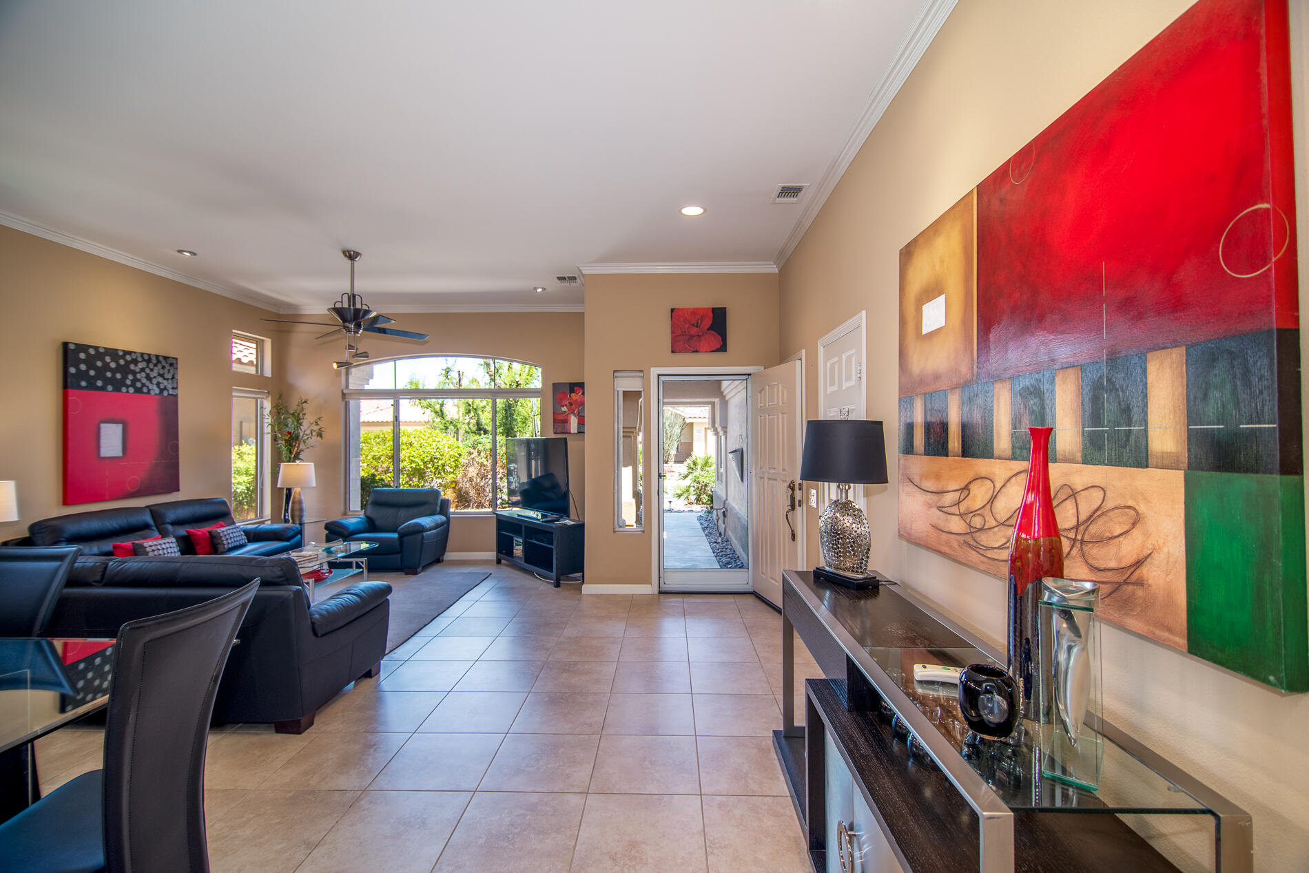 78379 Moongold Road Palm Desert, CA 92211 - Photo 17 of 40 a living room with furniture a flat screen tv and a dining table