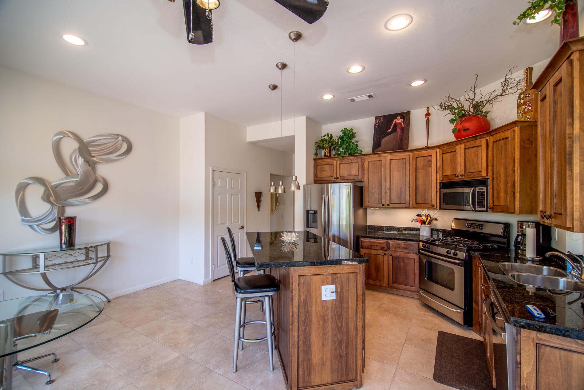 78379 Moongold Road Palm Desert, CA 92211 - Photo 20 of 40 a kitchen with stainless steel appliances granite countertop a refrigerator and a stove top oven