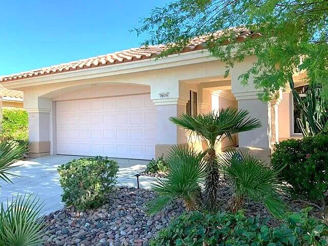 78379 Moongold Road Palm Desert, CA 92211 - Photo 2 of 40 a front view of a house with garden
