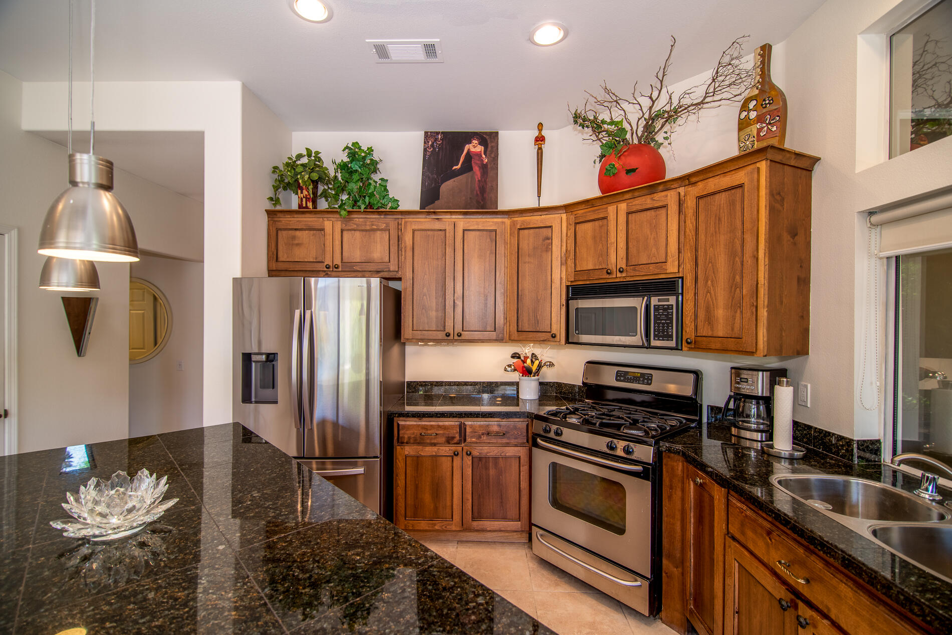 78379 Moongold Road Palm Desert, CA 92211 - Photo 22 of 40 a kitchen with stainless steel appliances granite countertop a refrigerator stove and sink