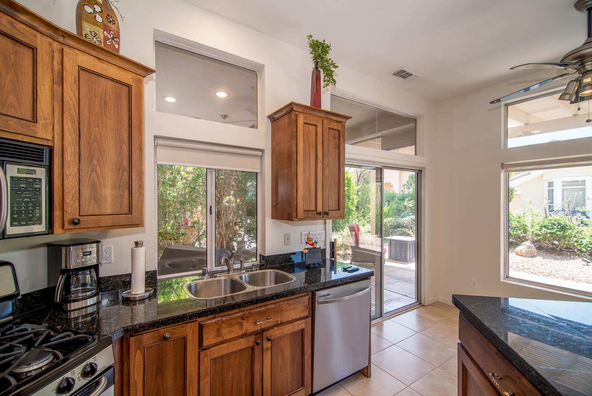 78379 Moongold Road Palm Desert, CA 92211 - Photo 23 of 40 a kitchen with stainless steel appliances granite countertop a sink a stove and a refrigerator
