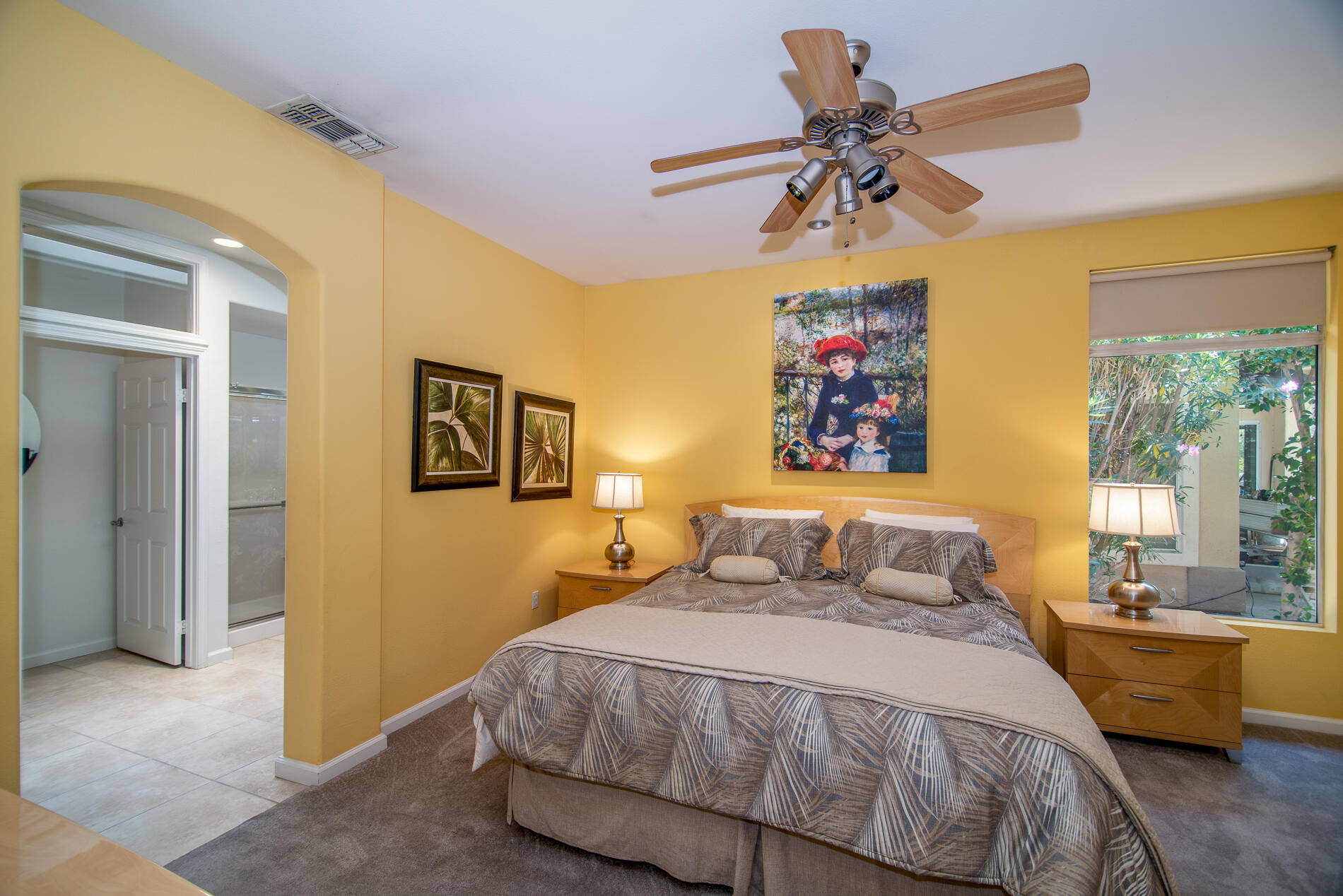 78379 Moongold Road Palm Desert, CA 92211 - Photo 26 of 40 a bedroom with a bed and a chandelier