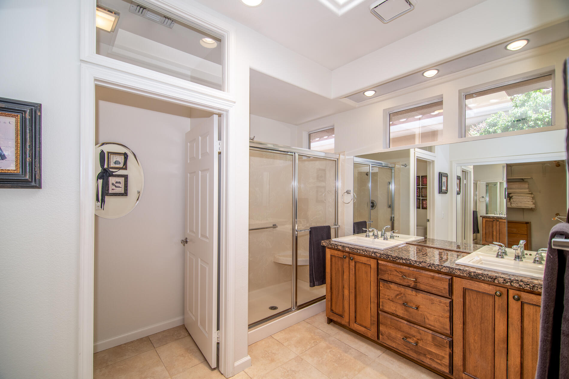78379 Moongold Road Palm Desert, CA 92211 - Photo 28 of 40 a bathroom with a double vanity sink a large mirror and a shower