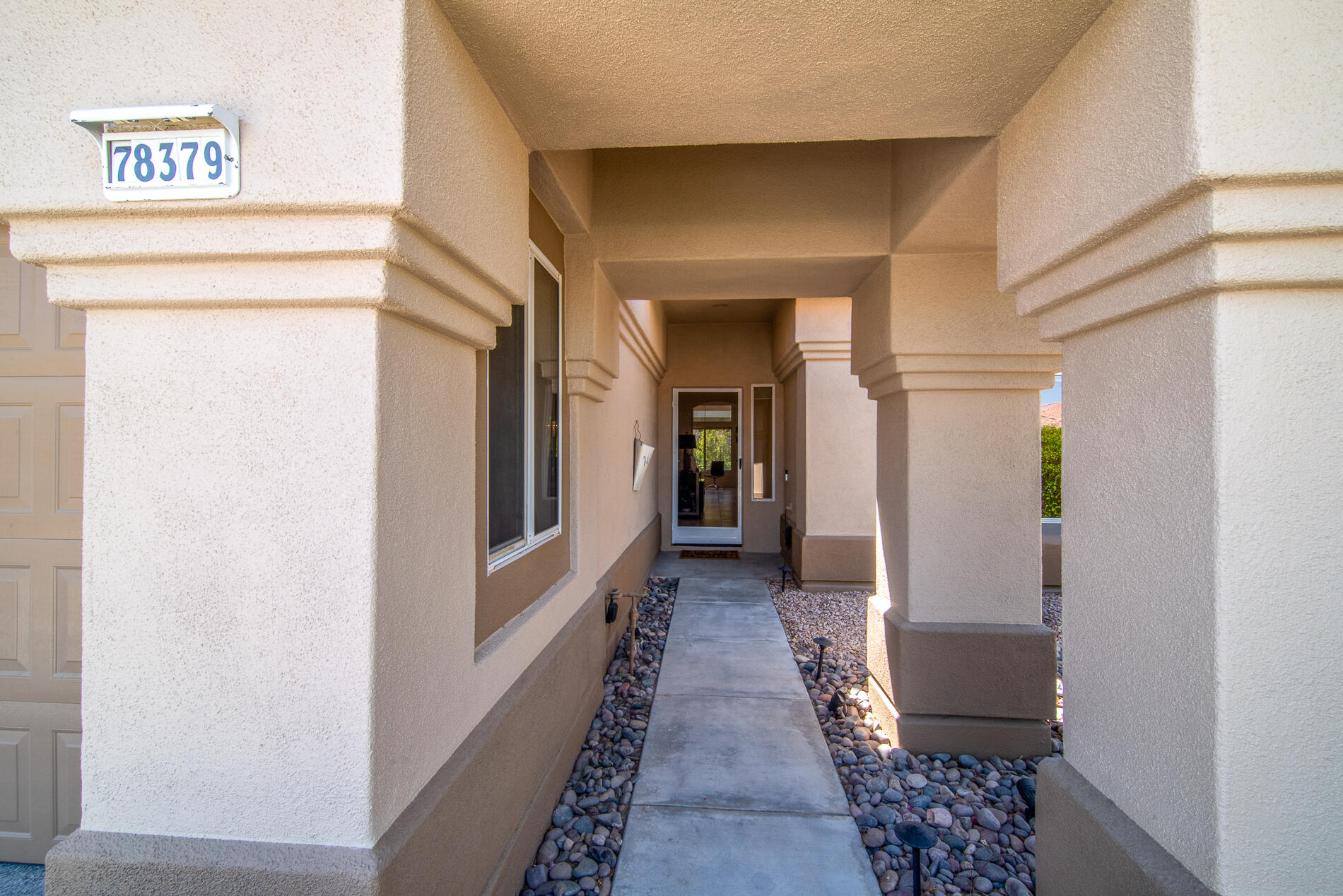 78379 Moongold Road Palm Desert, CA 92211 - Photo 3 of 40 a hallway with wooden floor windows and stairs