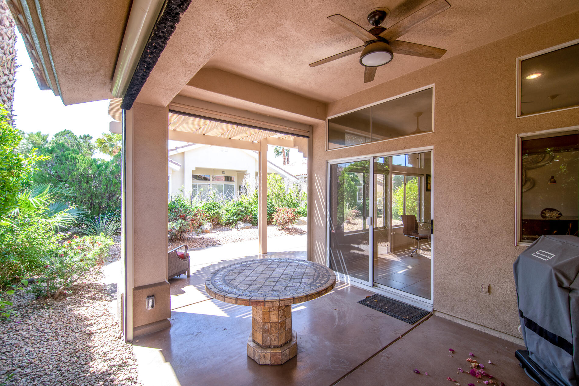 78379 Moongold Road Palm Desert, CA 92211 - Photo 33 of 40 a view of a porch with furniture and a backyard