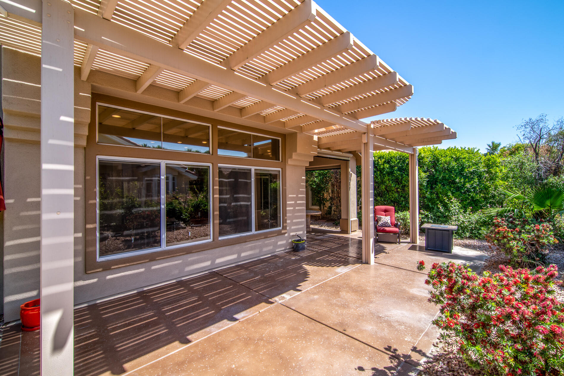 78379 Moongold Road Palm Desert, CA 92211 - Photo 7 of 40 a view of a porch with a table and chairs and potted plants