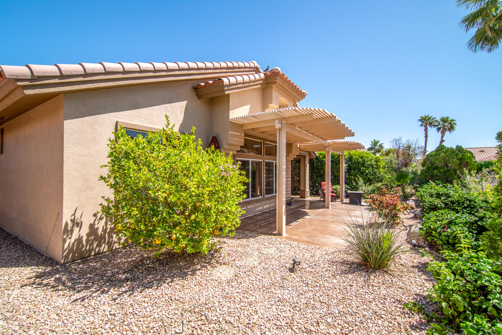 78379 Moongold Road Palm Desert, CA 92211 - Photo 8 of 40 a view of a house with a patio