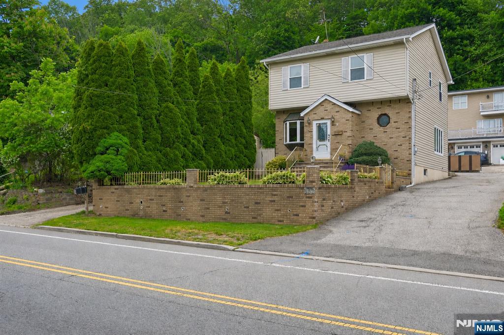 562 Valley Road Clifton, NJ 07013 - Photo 5 of 35 a view of a house with a small yard and large trees