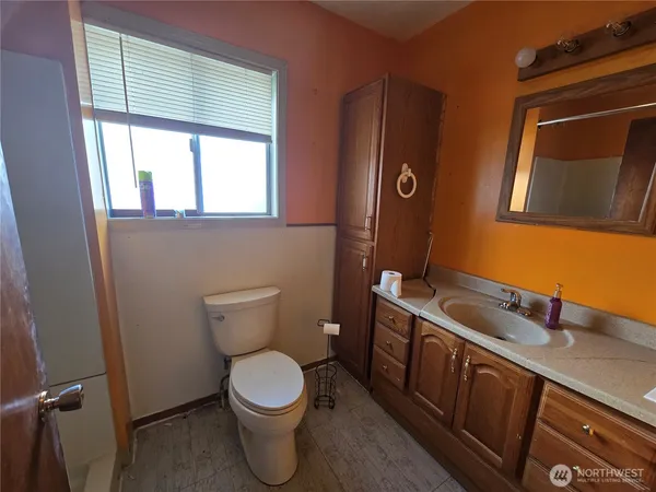 a bathroom with a toilet sink and mirror