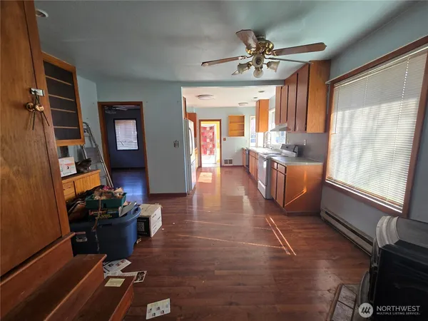 a living room with furniture a window and a flat screen tv