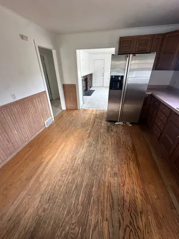 a kitchen with granite countertop stainless steel appliances a sink and wooden floors