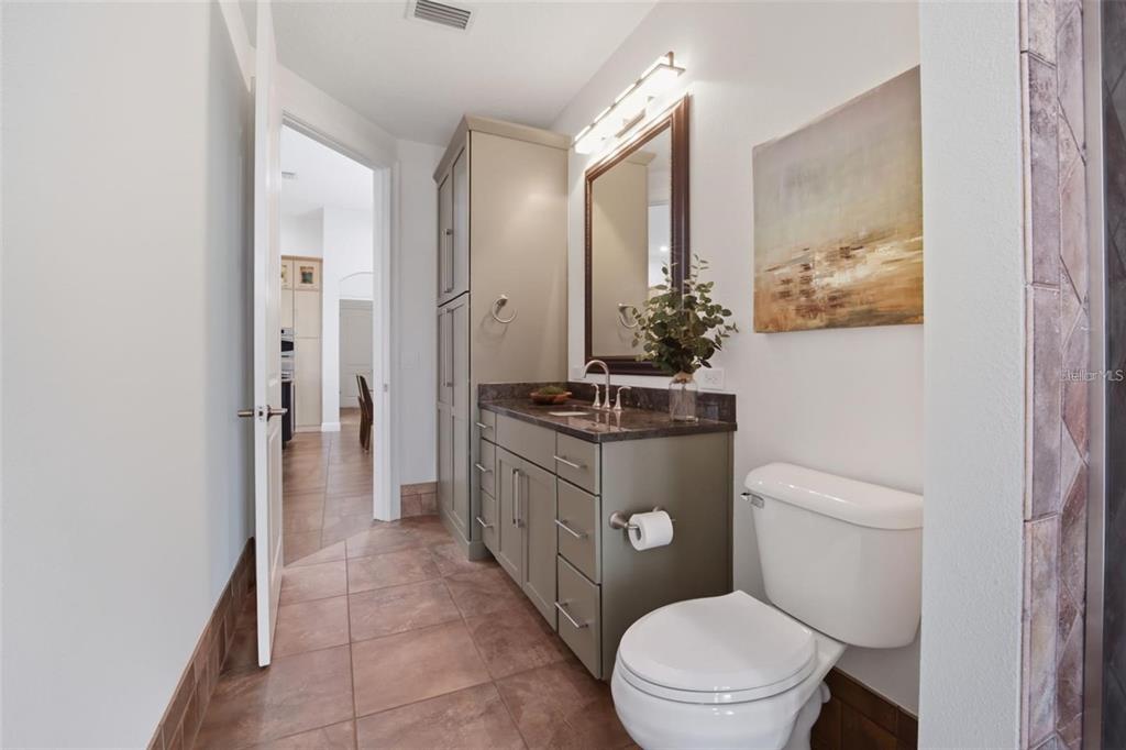 3215 Gulf City Road Ruskin, FL 33570 - Photo 22 of 99 a bathroom with a toilet a sink and a mirror
