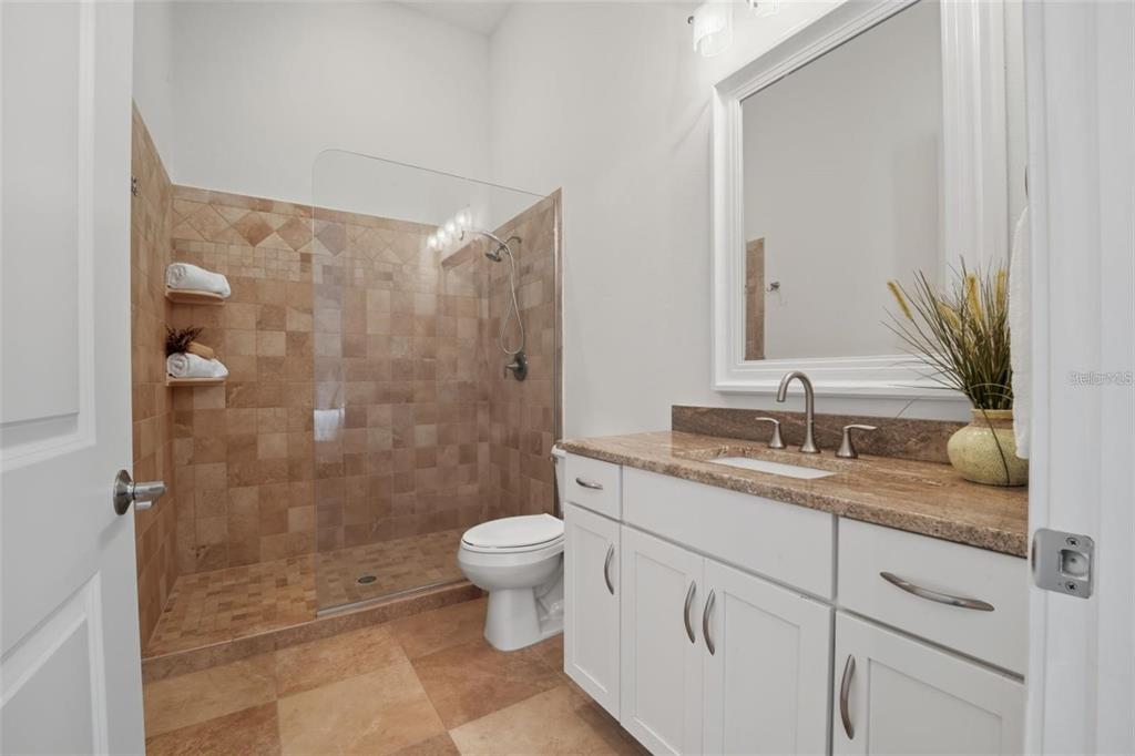 3215 Gulf City Road Ruskin, FL 33570 - Photo 36 of 99 a bathroom with a granite countertop sink a toilet and shower