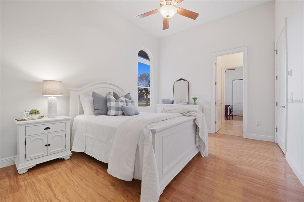 3215 Gulf City Road Ruskin, FL 33570 - Photo 59 of 99 a spacious bedroom with a bed and a chandelier