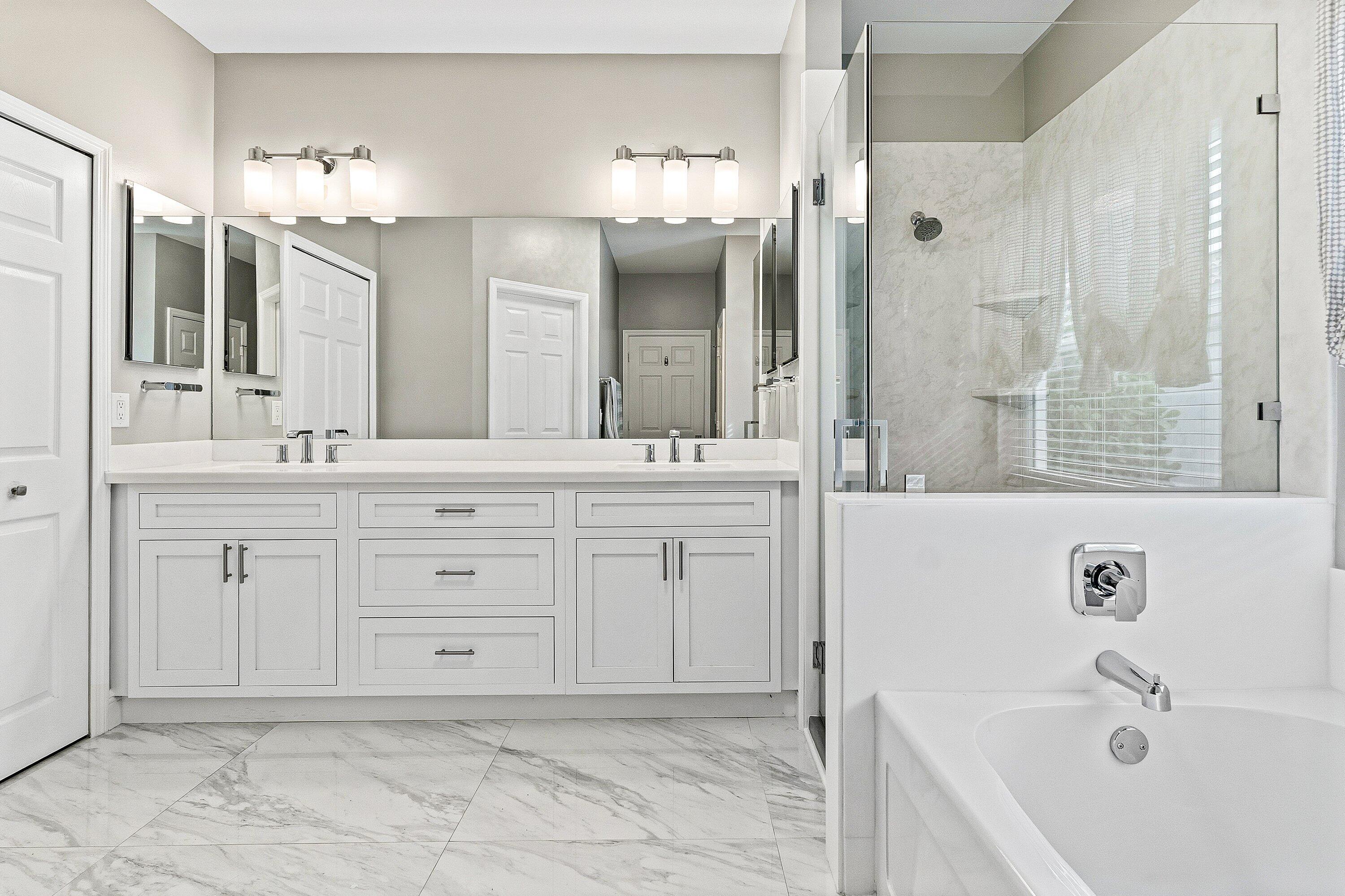12403 Cascades Pointe Drive Boca Raton, FL 33428 - Photo 19 of 65 a bathroom with a sink double vanity mirror and a bathtub