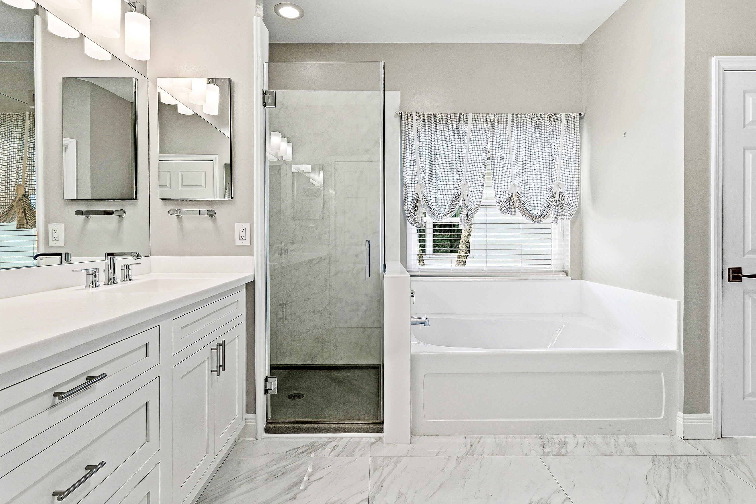 12403 Cascades Pointe Drive Boca Raton, FL 33428 - Photo 22 of 65 a bathroom with a bathtub shower sink vanity and mirror