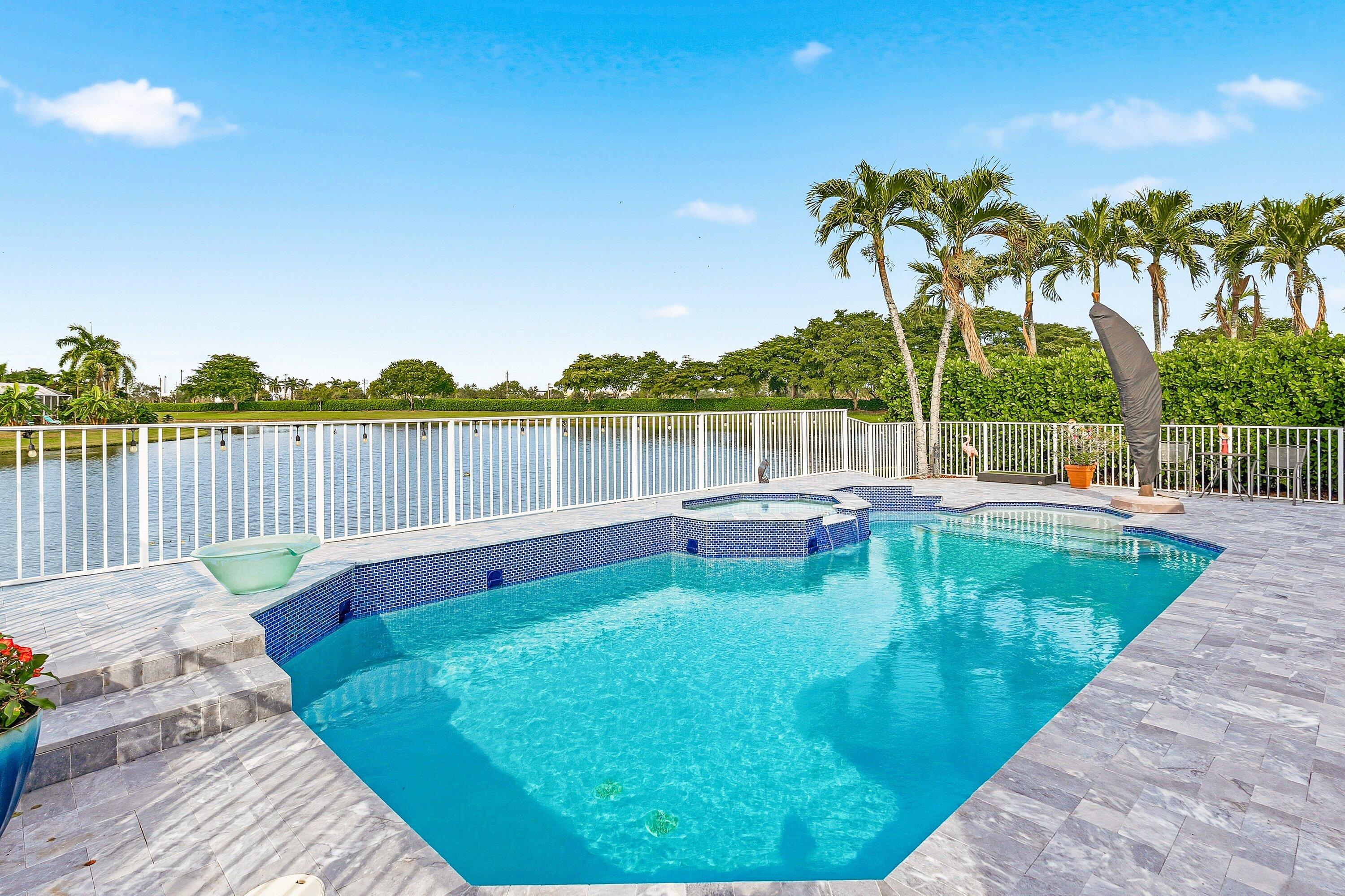 12403 Cascades Pointe Drive Boca Raton, FL 33428 - Photo 25 of 65 a view of a lake with sitting area