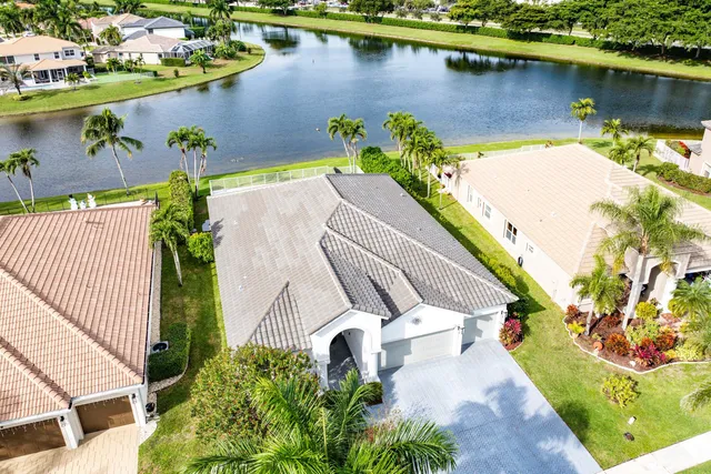 an aerial view of residential houses with outdoor space and parking