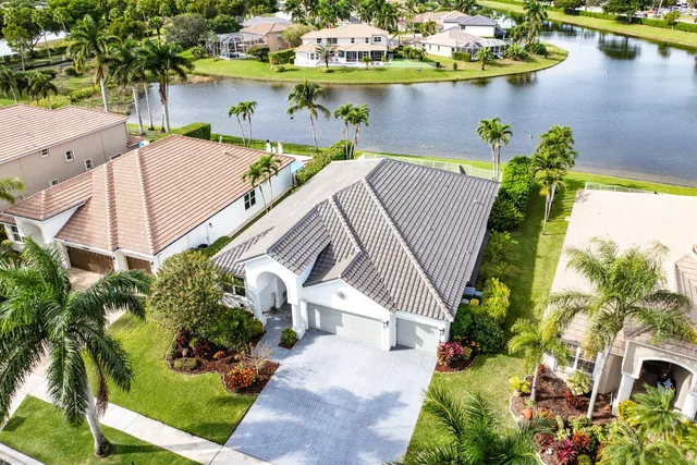 an aerial view of residential houses with outdoor space and trees