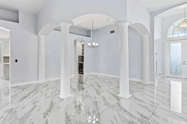 an empty room with floor to ceiling windows and pool table