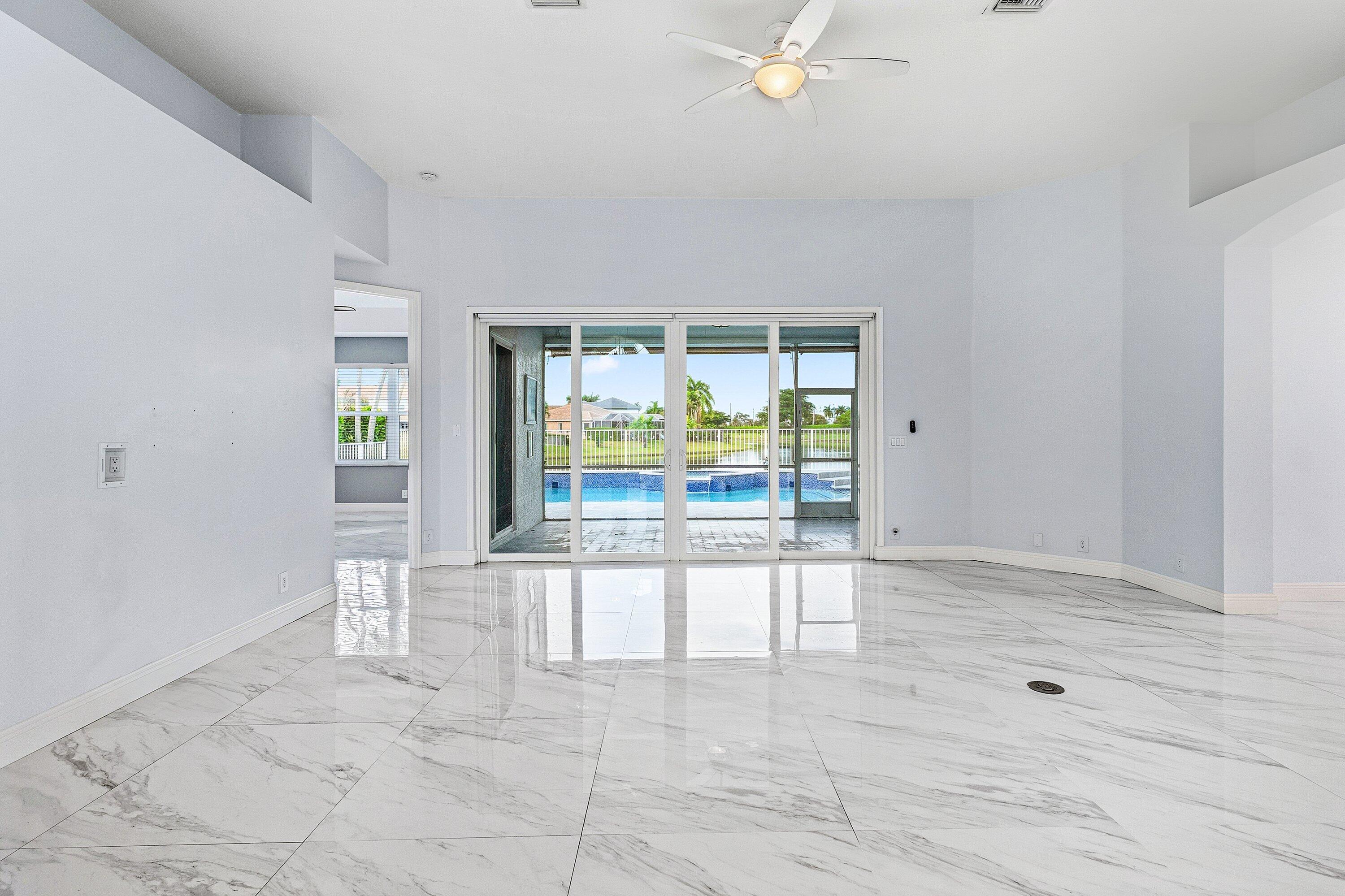 12403 Cascades Pointe Drive Boca Raton, FL 33428 - Photo 8 of 65 an empty room with floor to ceiling windows and pool table
