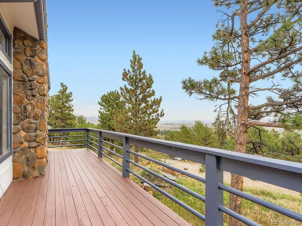a view of balcony with wooden floor and fence