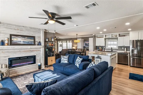 a open kitchen with stainless steel appliances granite countertop a stove and a refrigerator