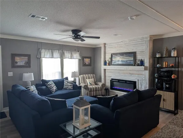 a living room with flat screen tv and a large window