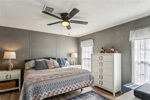 a bathroom with a granite countertop sink a mirror and a shower