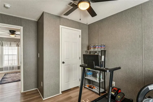 a view of a backyard with swimming pool and brick wall