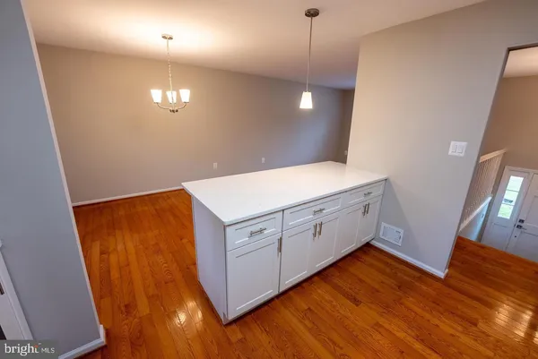 a view of a kitchen with wooden floor