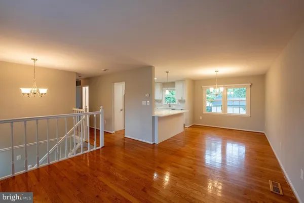 a view of a kitchen and wooden floor