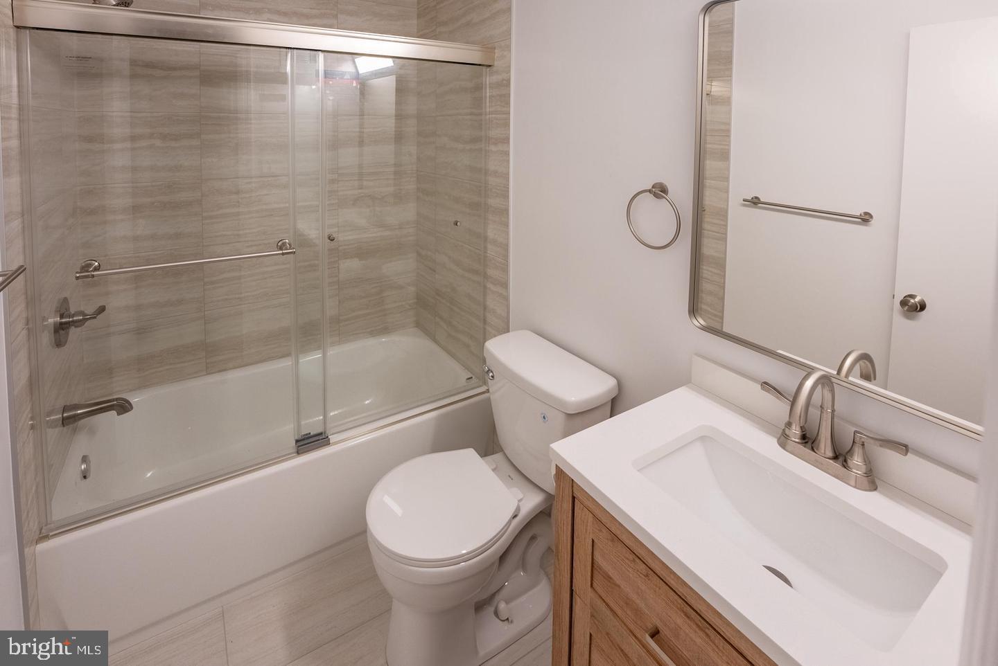 5629 Signal Point Court Burke, VA 22015 - Photo 18 of 48 a bathroom with a sink a toilet and shower