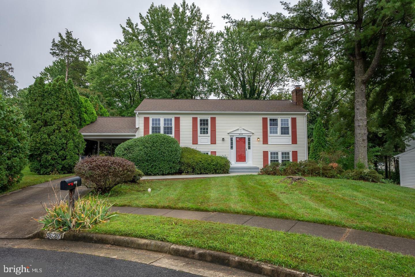 5629 Signal Point Court Burke, VA 22015 - Photo 2 of 48 a front view of a house with a garden and plants