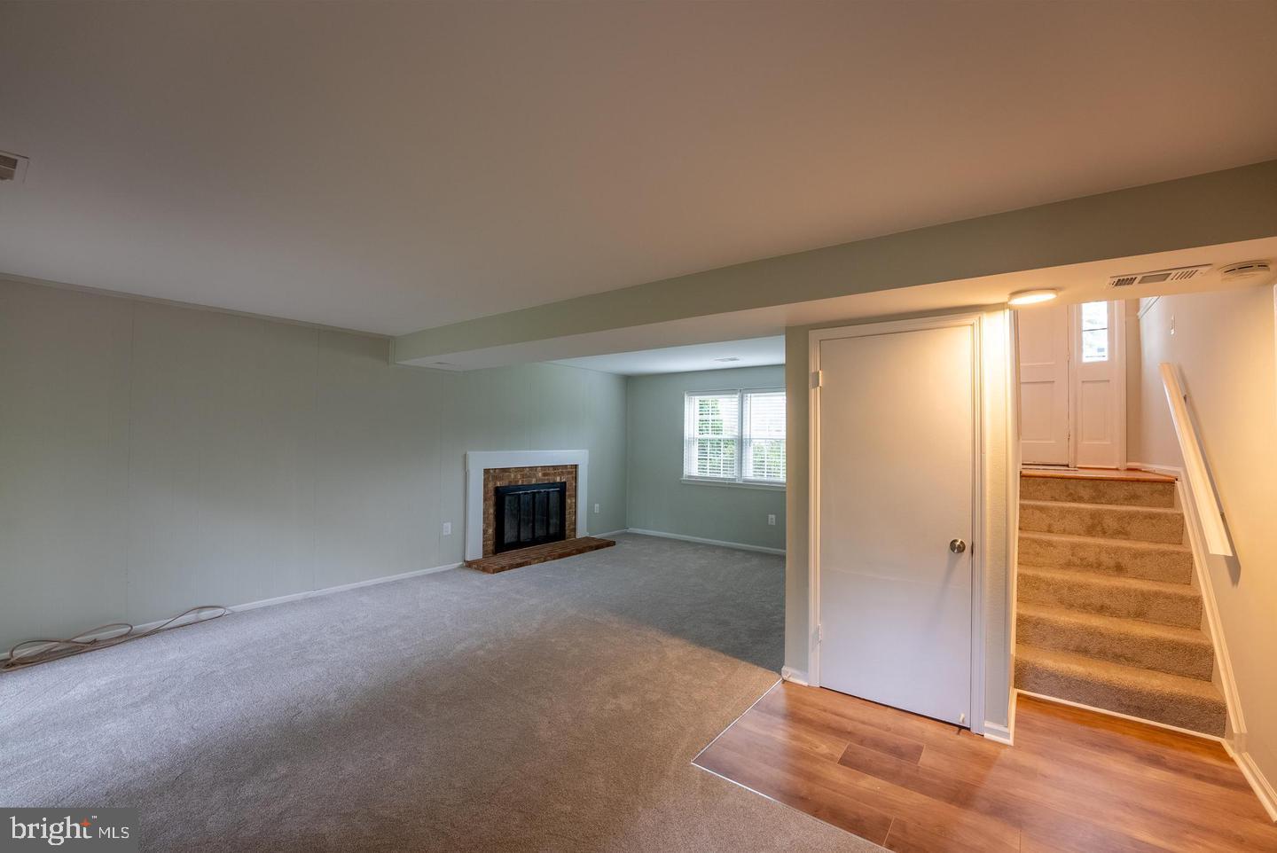 5629 Signal Point Court Burke, VA 22015 - Photo 21 of 48 an empty room with windows and fireplace