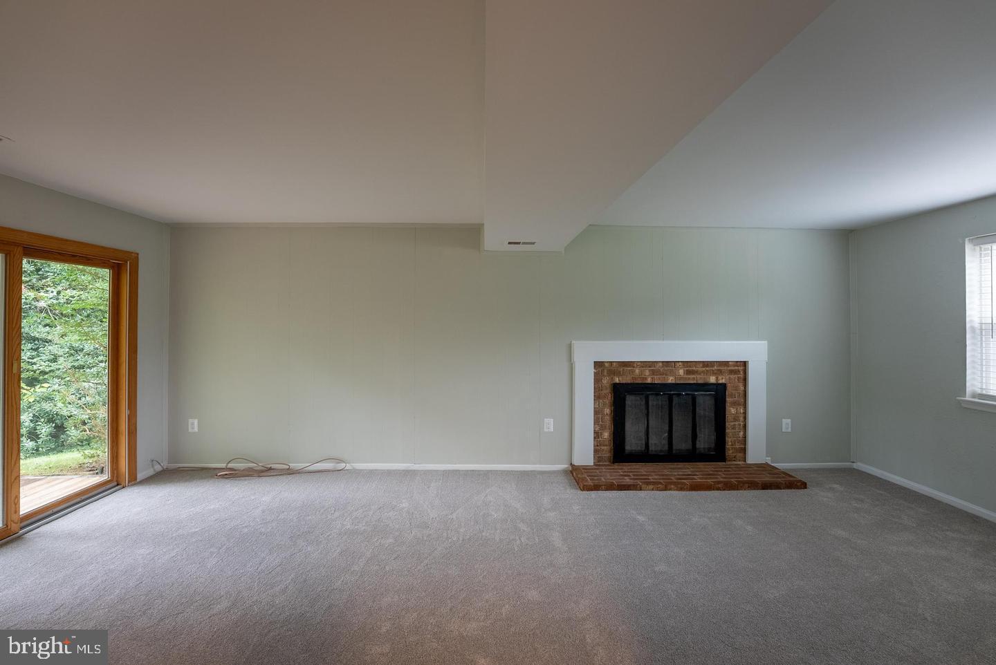5629 Signal Point Court Burke, VA 22015 - Photo 22 of 48 an empty room with a fireplace and window
