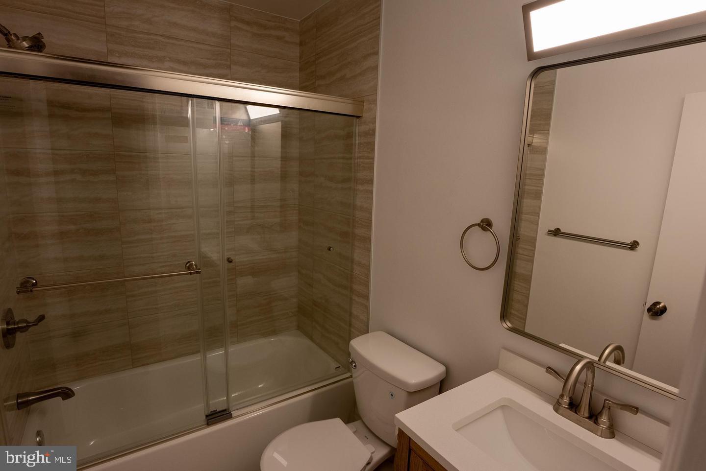 5629 Signal Point Court Burke, VA 22015 - Photo 28 of 48 a bathroom with a sink mirror toilet and shower