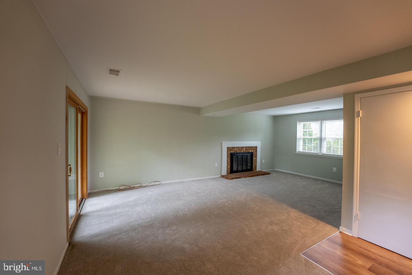 5629 Signal Point Court Burke, VA 22015 - Photo 32 of 48 a view of an empty room with wooden floor and a window
