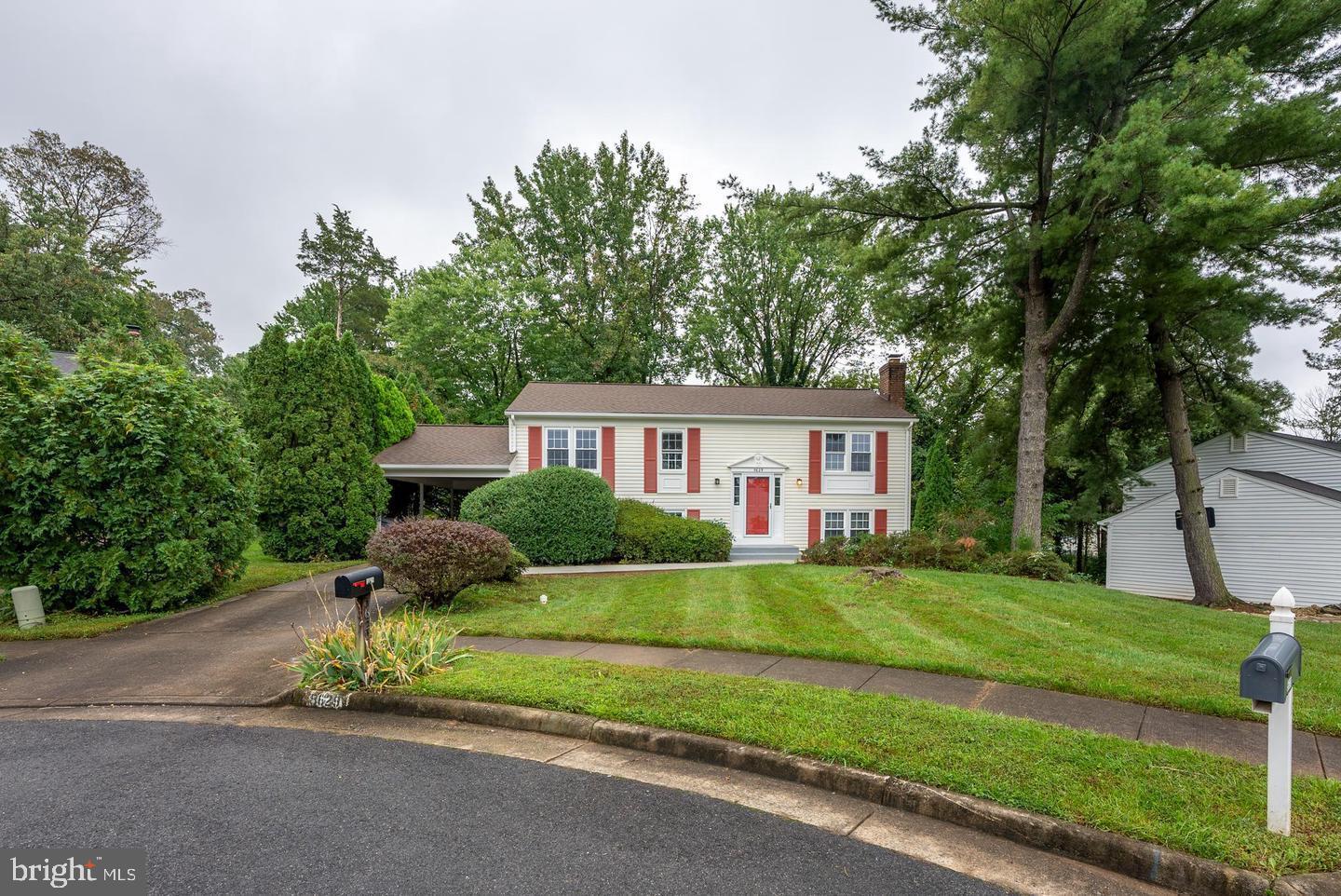 5629 Signal Point Court Burke, VA 22015 - Photo 4 of 48 a front view of a house with a yard and garage