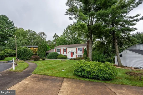 a view of a house with a yard and tree s