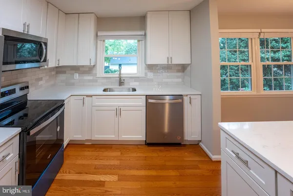 a kitchen with a sink stove and microwave