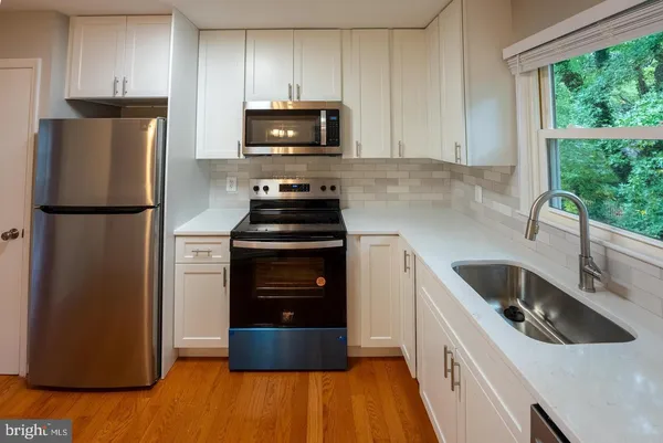 a kitchen with a refrigerator sink and stove