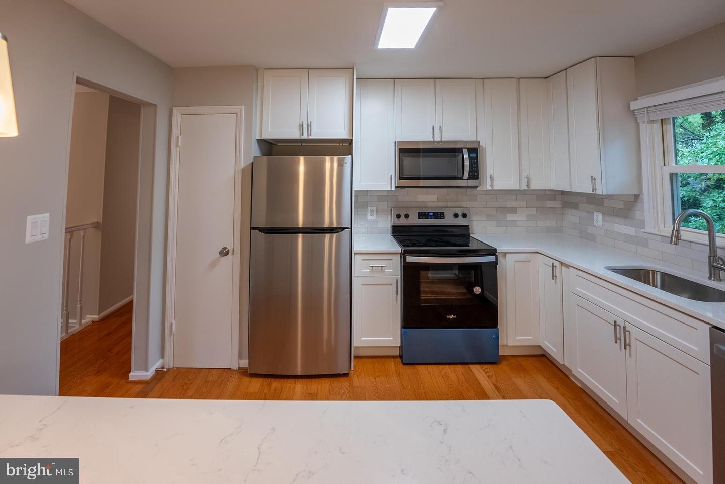 5629 Signal Point Court Burke, VA 22015 - Photo 9 of 48 a kitchen with a refrigerator and a stove top oven