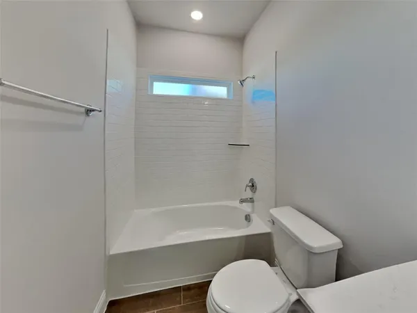 a bathroom with a toilet and a bathtub