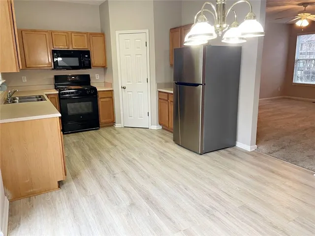 a kitchen with a refrigerator a stove top oven a sink and dishwasher