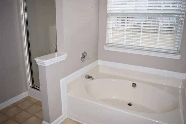 a white bath tub sitting next to a window