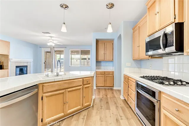 a kitchen with stainless steel appliances granite countertop a stove and a microwave
